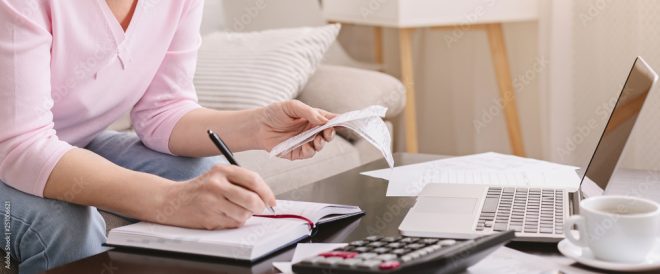 A woman performing accounting and bookkeeping. She is ensuring her business is up to FAR standards.