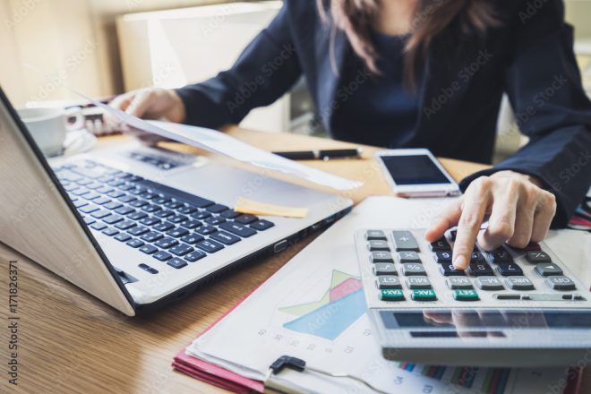 A woman examining indirect costs in relation to accounting.