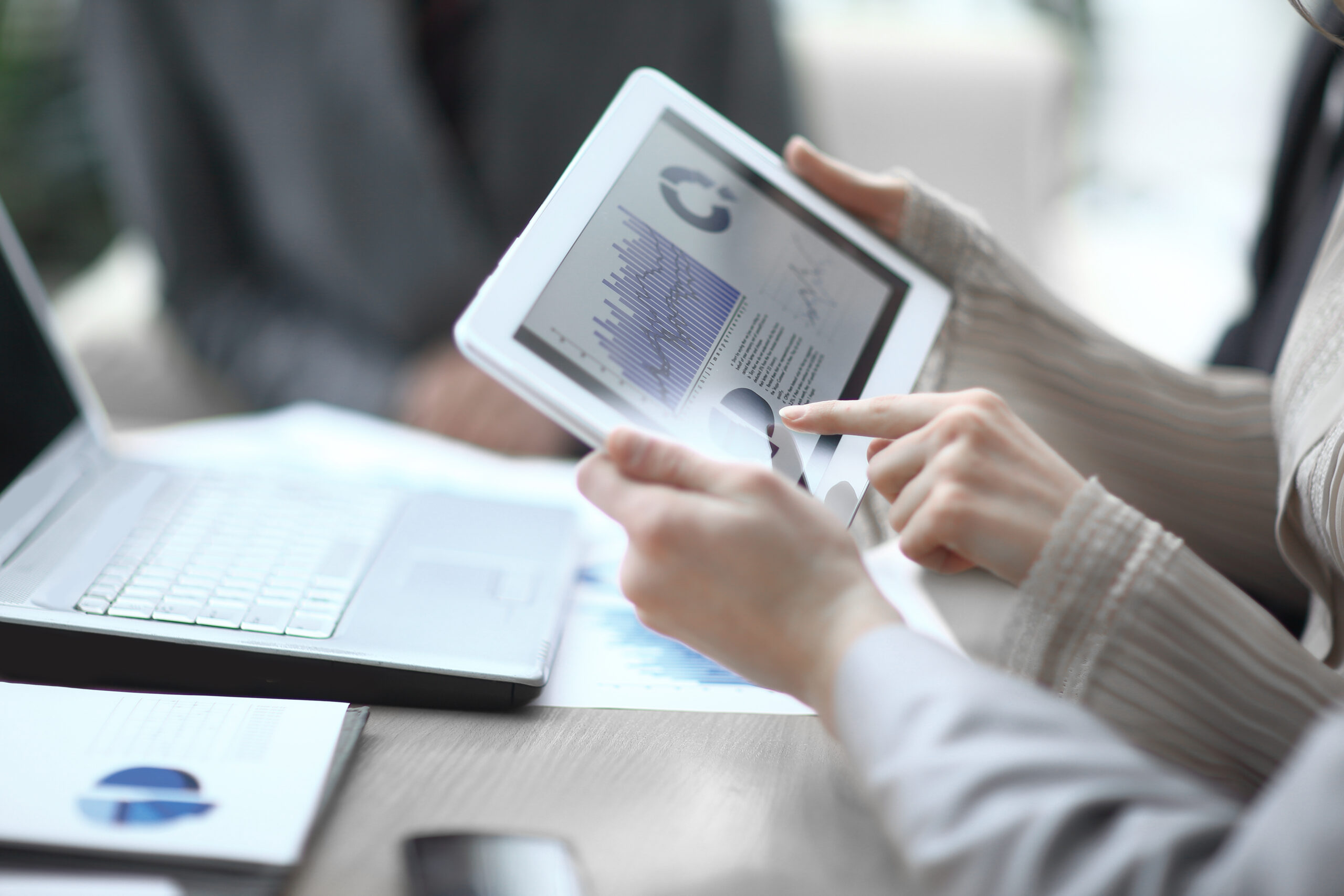 close up.the business team uses a digital tablet to verify financial data close up. the business team uses a digital tablet to verify financial data.