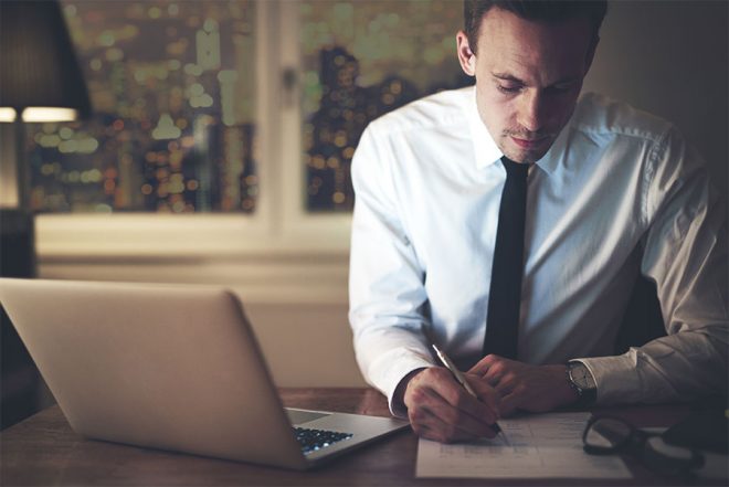 A man calculating software costs.